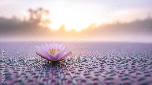 Lotus on yoga mat at sunrise, symbolizing peace and mindfulness on International Yoga Day