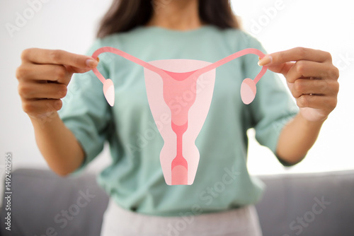 Woman holding Uterus and Ovaries Model. Ovarian and Cervical Cancer, Reproductive System and Pregnancy Concept.