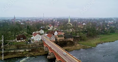Aerial View of a Historic Bridge and the Scenic Townscape Nearby a Beautiful Water Body Kuldiga Latvia