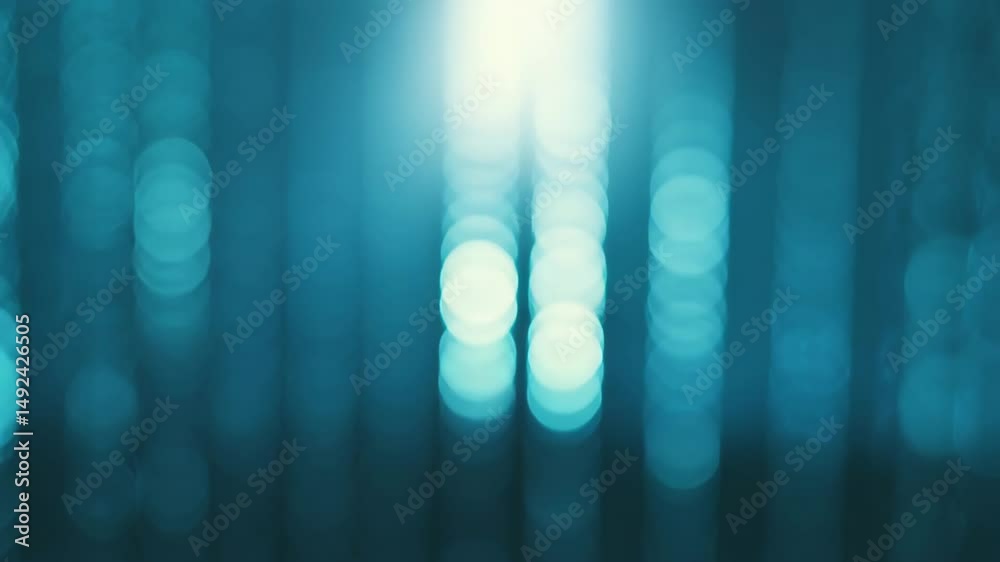 Elegant blue bokeh lights move upwards, beautiful abstract background with a sense of sophistication. Soft blue bokeh lights floating upward, ethereal background, depth and elegant visual movement