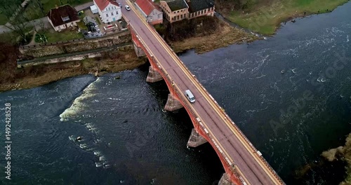 Aerial View of a Majestic Scenic River Bridge, Beautifully Surrounded by Lush Nature Kuldiga Latvia