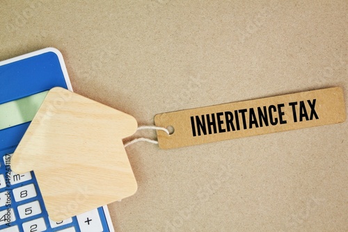 house form and paper tag with the word Inheritance Tax. An inheritance tax is a tax paid by a person who inherits money or property of a person who has died