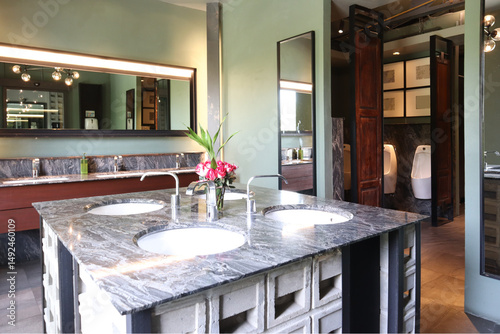 Retro public toilet show variety of materials on sink, wooden door and mirror to promote classic atmosphere.
