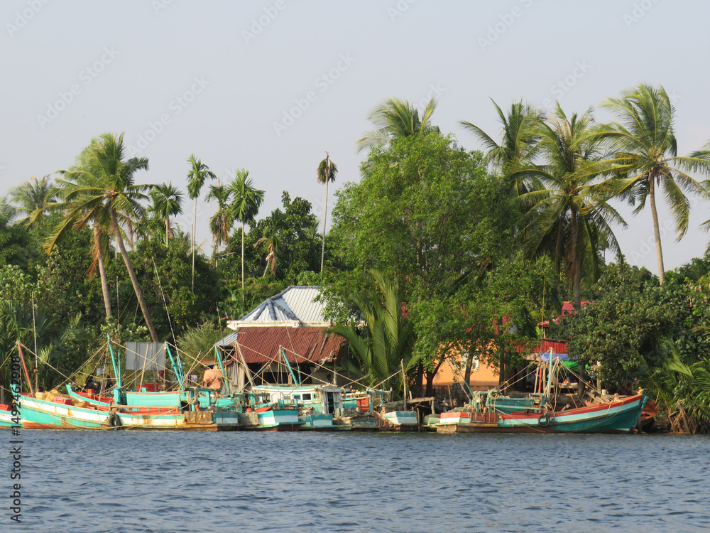 Boats and dwellings on the banks of the Praek Tuek Chhu River in Kampot, Cambodia Boats and dwellings on the banks of the Praek Tuek Chhu River in Kampot, Cambodia