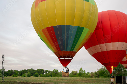 A vibrant aerostat balloon takes off and ascends into the sky