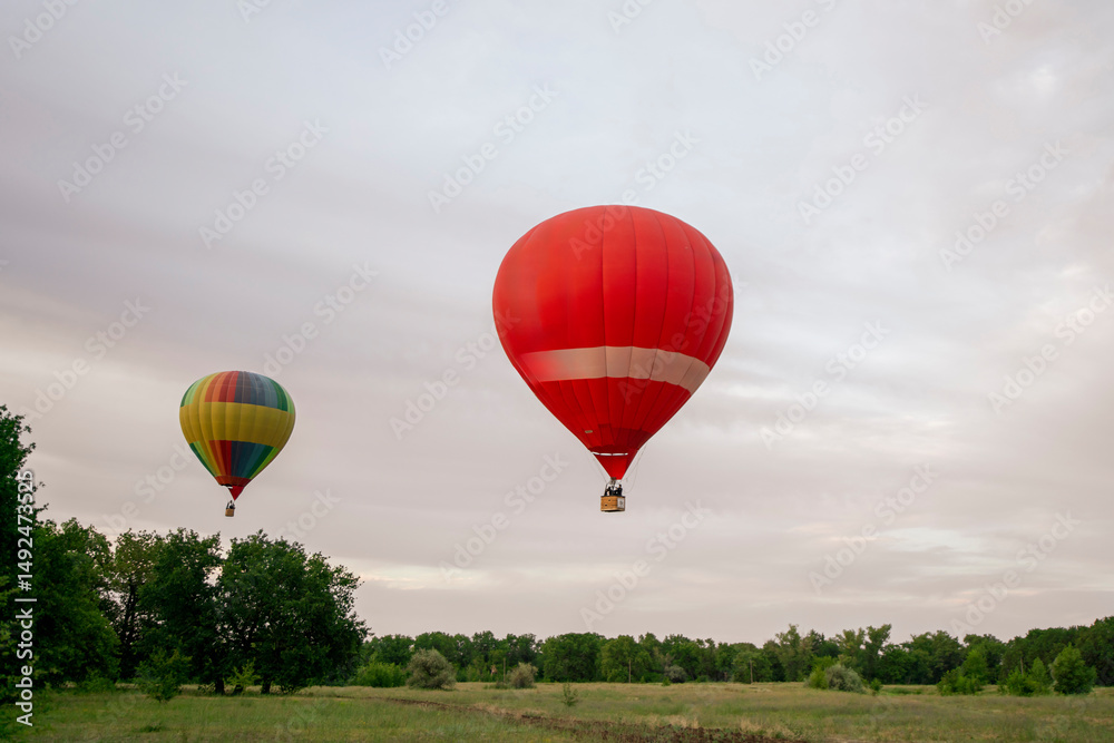 Fototapeta premium A vibrant aerostat balloon takes off and ascends into the sky