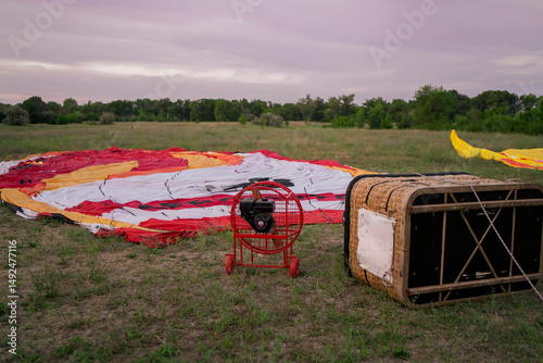 Large aerostat balloon is spread out on the ground