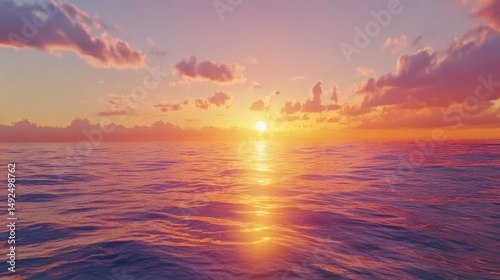 The warm golden light of the sun setting over the ocean, casting a shimmering reflection on the water and painting the sky with rich hues of orange, pink, and purple