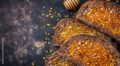 Honey-drizzled dark bread slices on rustic background photo