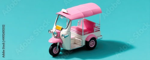 A pink and white tuk-tuk model is displayed on a vibrant turquoise background.