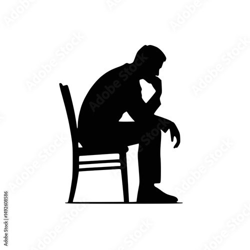 Silhouette of man sitting and thinking with hand on chin
