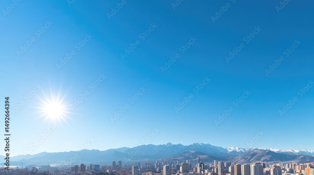 Fototapeta premium Cityscape view from above with snow capped mountains