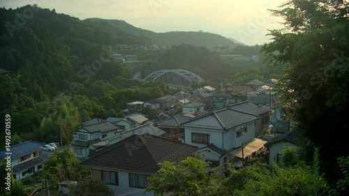 Wallpaper Mural Quiet village in Japan’s green mountains beside river at dusk. Torontodigital.ca