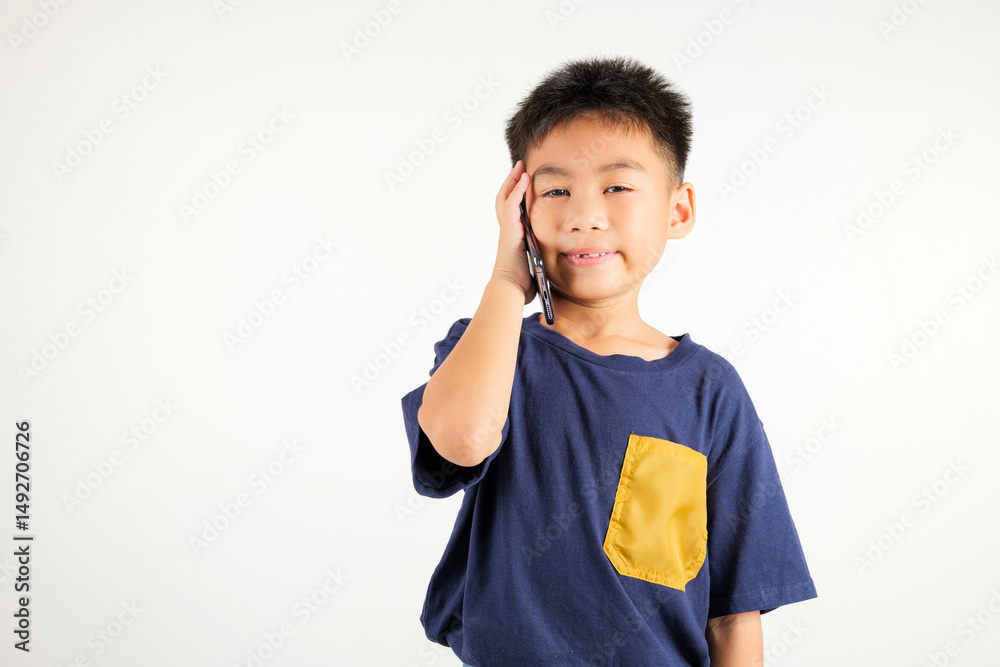 Happy Asian portrait cute young kid boy smiling excited talking smart mobile phone studio shot isolated on white background, Thai child calling gesture on smartphone Happy Asian portrait cute young kid boy smiling excited talking smart mobile phone studio shot isolated on white background, Thai child calling gesture on smartphone