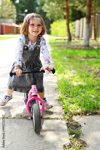 Kid girl on balance bike