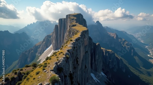 Midday view of Penalara Peak in Spain, with cloudy skies and a sweeping aerial perspective of the rocky peak.