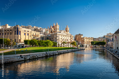 Spectacular view of seaport Vittoriosa and St. Lawrence's Catholic Church. Location place Birgu harbour, Malta, Europe. Photo wallpapers. Golden hour.
