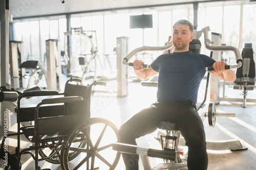 Wallpaper Mural Man with disability working out with chest press machine in rehabilitation gym Torontodigital.ca