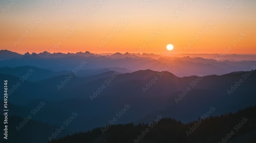 Fototapeta premium A sunset view from a mountain summit, with layers of peaks fading into the distance