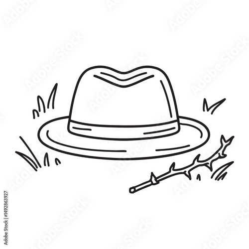 A vine thorn lying beside a worn out hat