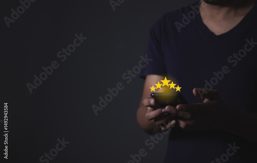 Customer Review, Young Man hand holding Smart Phone with five star to review and give 5 stars with very good results in service, Good review 5 star rating choice feedback