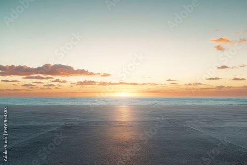 Fototapeta Naklejka Na Ścianę i Meble -  Serene sunset over calm ocean, reflected on empty asphalt