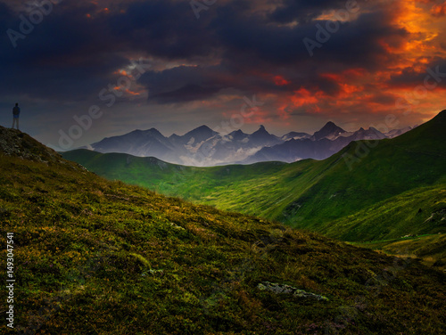 Man tourist watching mountains near Saalbach Hinterglemm Leogang ski resort during summer day, Creative post processing