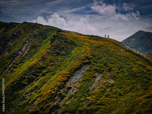 People walking on a mountains range  near Saalbach Hinterglemm Leogang ski resort during summer day
