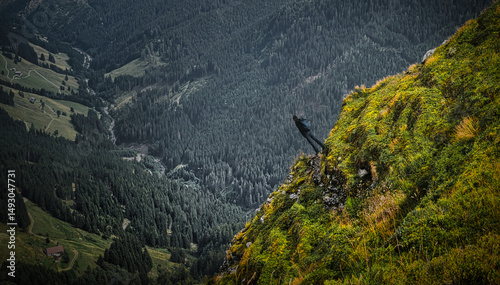 Man tourist watching mountains near Saalbach Hinterglemm Leogang ski resort during summer day, Creative post processing