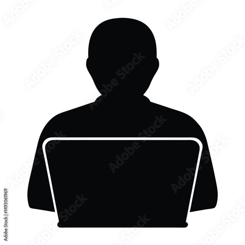 Silhouette of a person using a laptop, facing away from the viewer