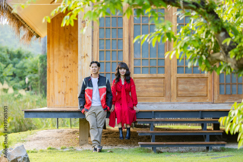 Romantic time together. Happy asian couple tourist sitting on terrace at a Japanese style homestay at countryside on vacation.