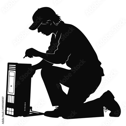 Technician repairing a computer in silhouette, kneeling down for careful access