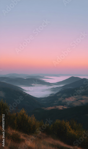 Serene dawn breaking over misty mountains as the sun paints the sky with pastel hues of pink