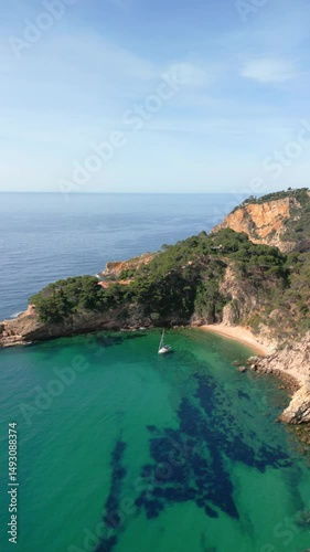 Scenic mediterranean cove with boat at costa brava coastline
