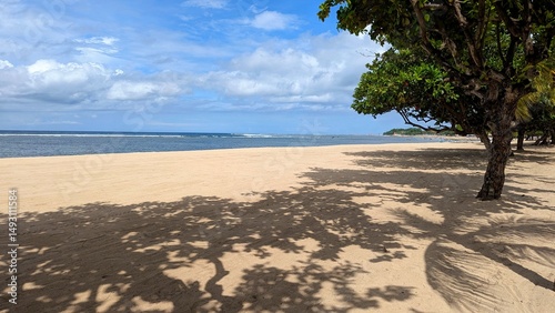 Scenic view of Sanur beach in Denpasar on tropical island of Bali Indonesia with white sand and ocean views
