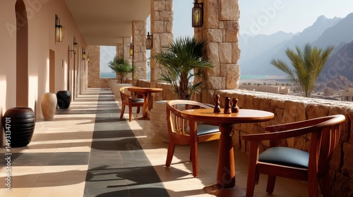 Warm pastel light falls across a desert resort terrace, polished wood furniture and aged stone harmonizing with nature