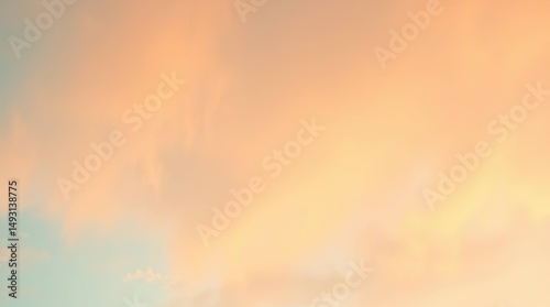 Soft pastel sunset sky with clouds creating a peaceful golden hour scene