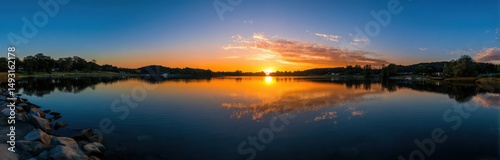 Panoramic View of Lake at Sunset With Reflections, Representing Tranquility and Environmental Conservation for Tourism Promotion : Generative AI