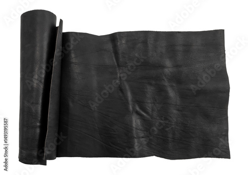 A rolled piece of black genuine leather on a white background. Piece of leather