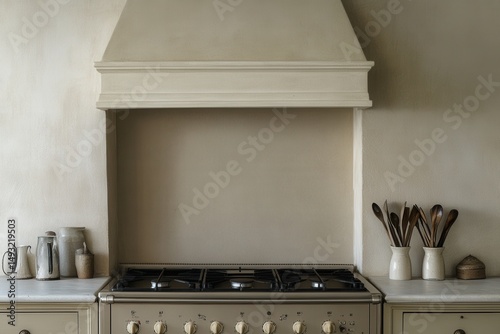 Modern Kitchen with Cream Colored Range Hood, Gas Stove, Minimalistic Design, Wooden Utensils, and Charming Pottery Accents in a Cozy Culinary Space