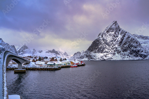 Hamnoy bridge covered with snow in winter, most popular iconic snowy bridge in Homnoy fisherman village, Lofoten Norway
