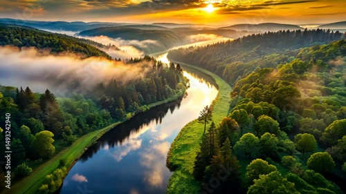Serene River Winds Through Lush Green Forests at Golden Hour