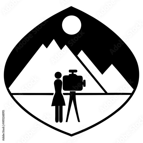Woman filming mountain landscape at sunset