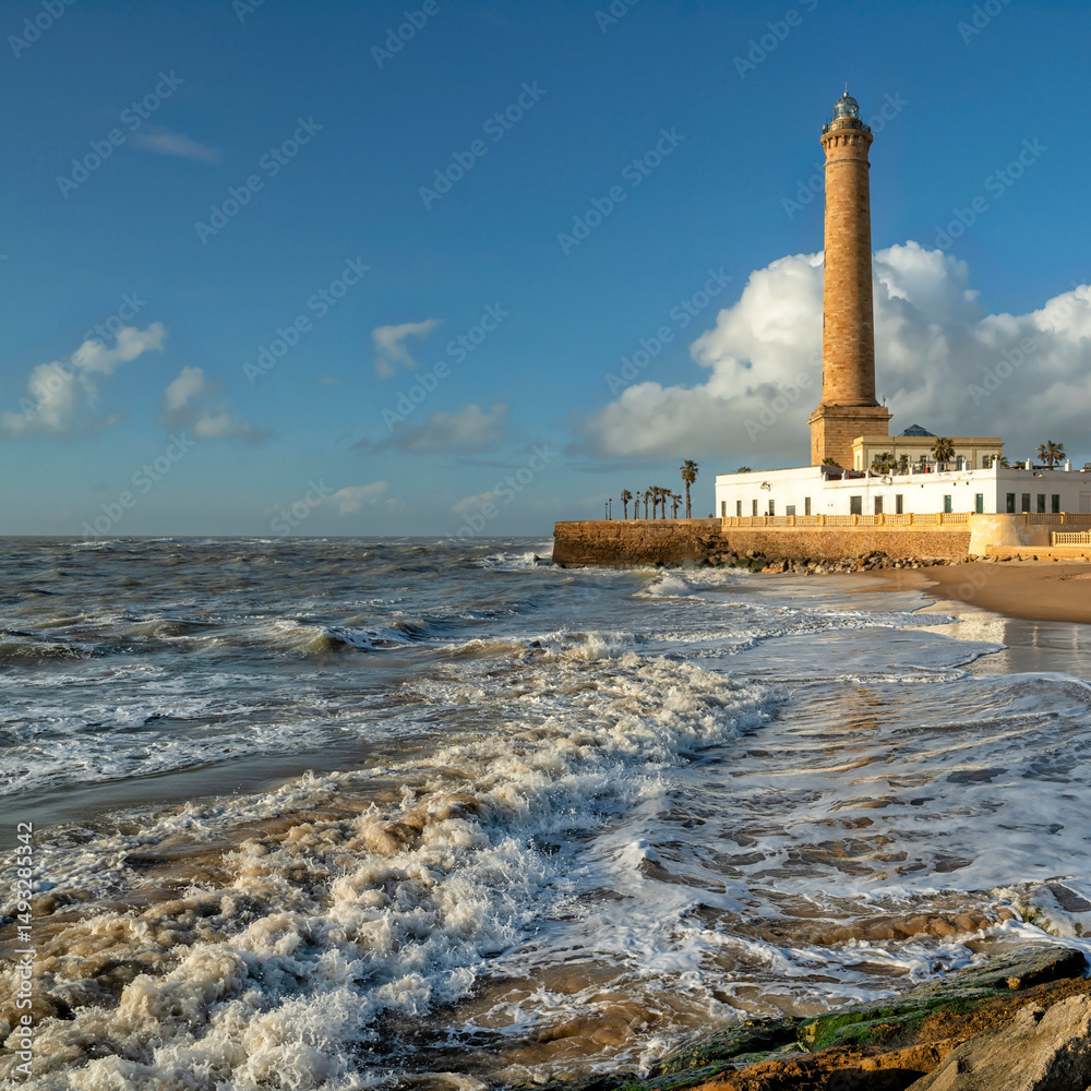 Fototapeta premium Chipiona, Spain. Chipiona Lighthouse on the Ocean Shore 