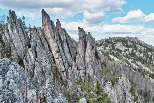 Jagged rock peaks and forested mountains, Two-headed sopka, in Taganay National Park, Russia