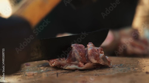 Senegalese Chef Craft: Extreme Close-up of African Hands Hacking Raw Meat with Machete Hammer, Artistic Motion Blur, Traditional Butcher Preparation