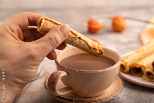Waffles with caramel on brown concrete, orange textile, side view, close up, selective focus