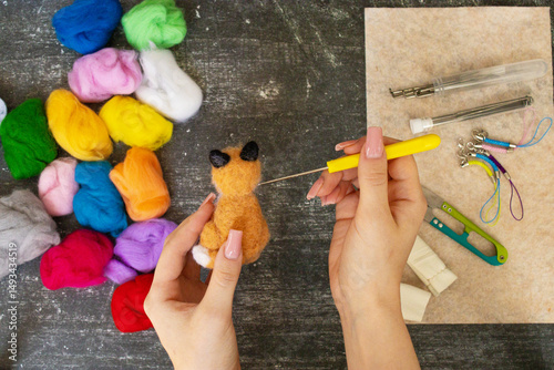 Felting process with wool and tools. Handmade wool toys in progress. Perfect for craft projects, DIY, needle felting, and creative textile work.