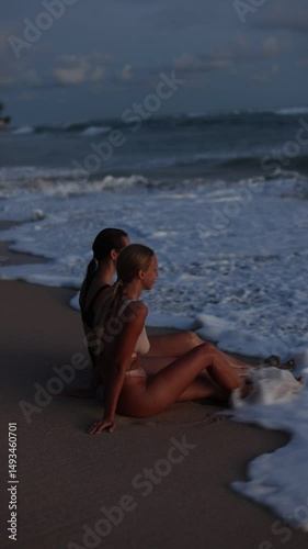 Two Women Beautifully Posing Together in Beach Silhouette at Stunning Sunset Time