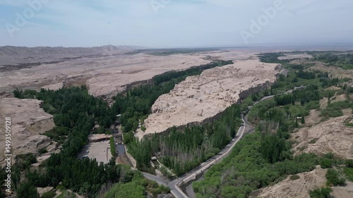 Wallpaper Mural Turpan, China: Aerial drone footage of the ruins of the famous Jiaohe ancient city that lies on a plateau surrounded by steep cliff in Turpan in Xinjiang, China. Shot with an orbit motion Torontodigital.ca